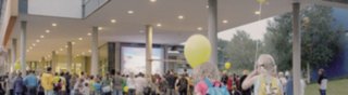 Children with balloons standing in a crowd